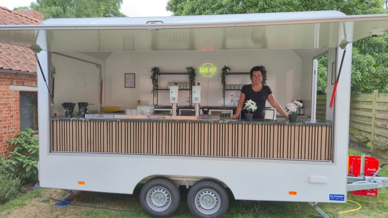 Nadine glimlachend achter de Bar-Kaar trailer